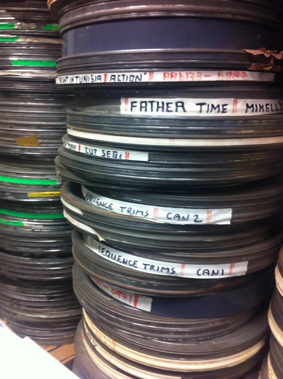 Stacked film reels with handwritten labels — from the RIMS CIC moving image archive