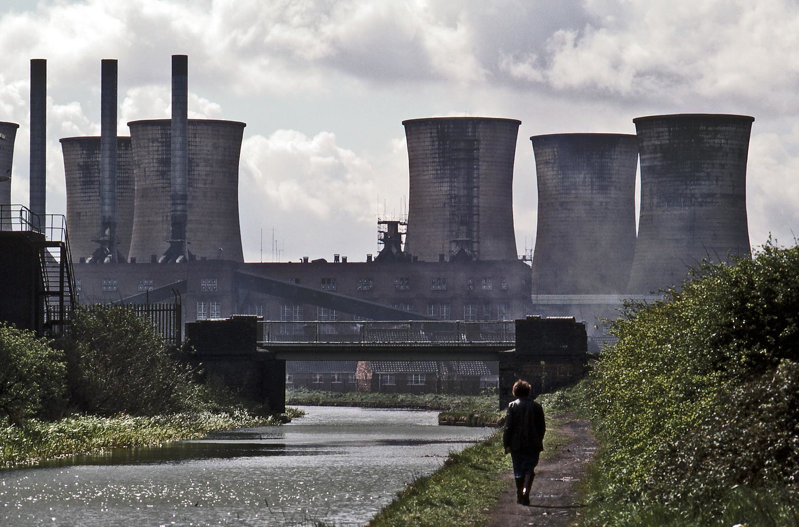 Black Country road with bus and steelworks on the horizon, 1970s