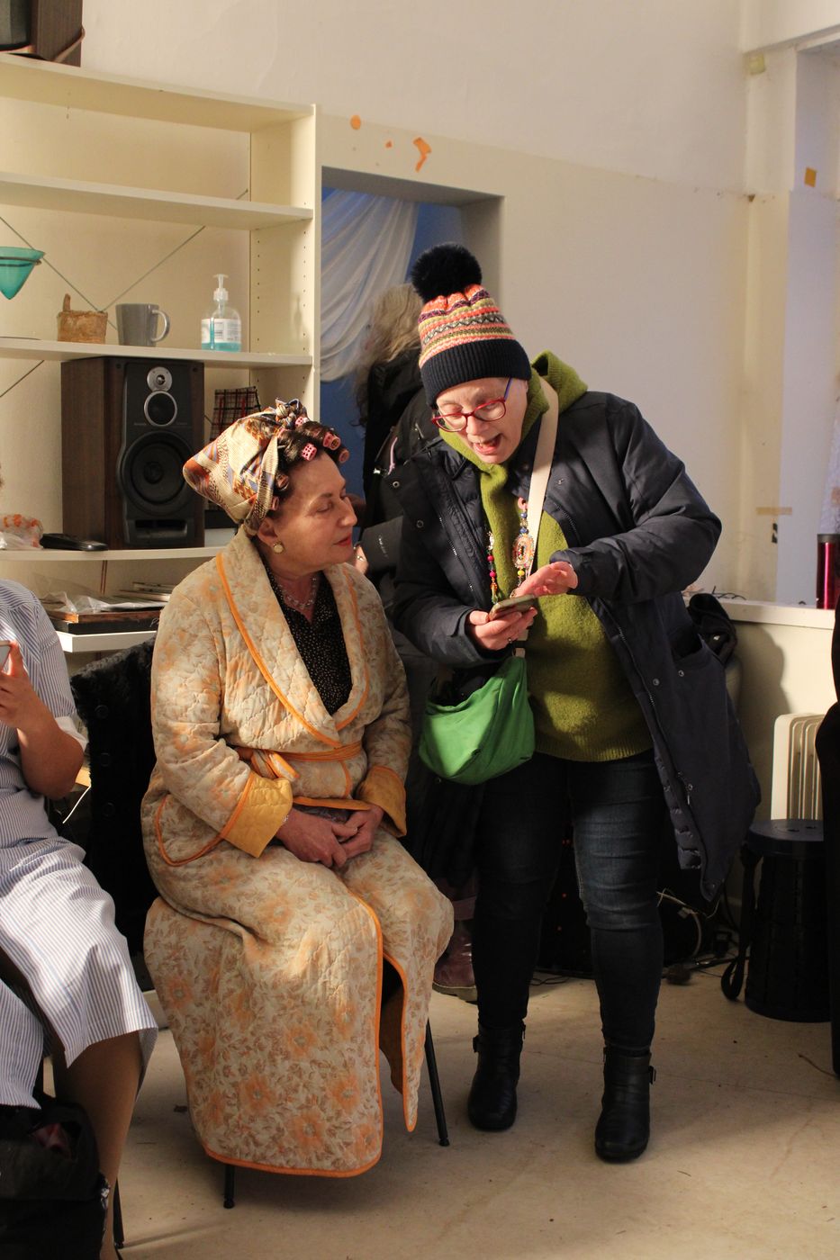 Cast being prepared for a scene — makeup and final checks