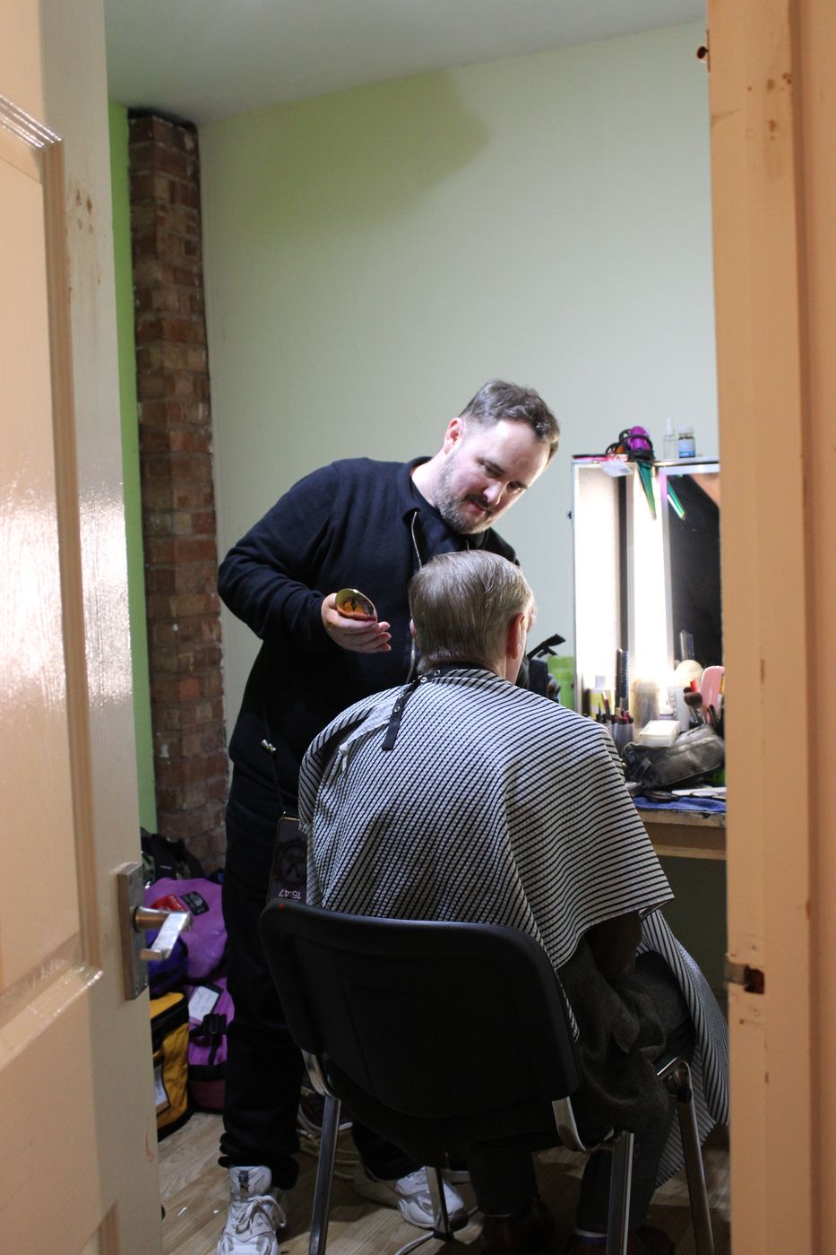 Crew member in hi-vis on set — production underway in Walsall
