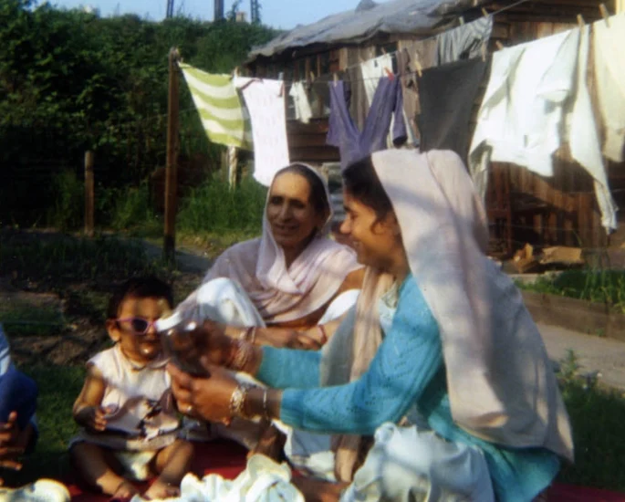 Women and a child in a garden with laundry drying, domestic life in the Black Country