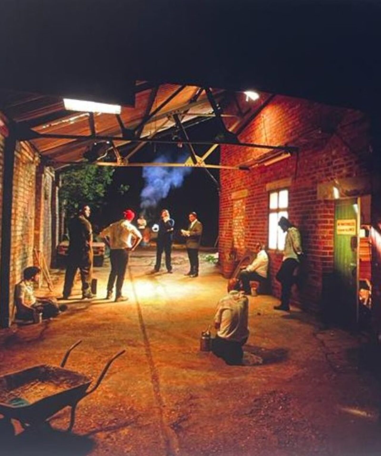 Cast and crew gathered in the foundry warehouse set at night, preparing the Furnace Men tableau