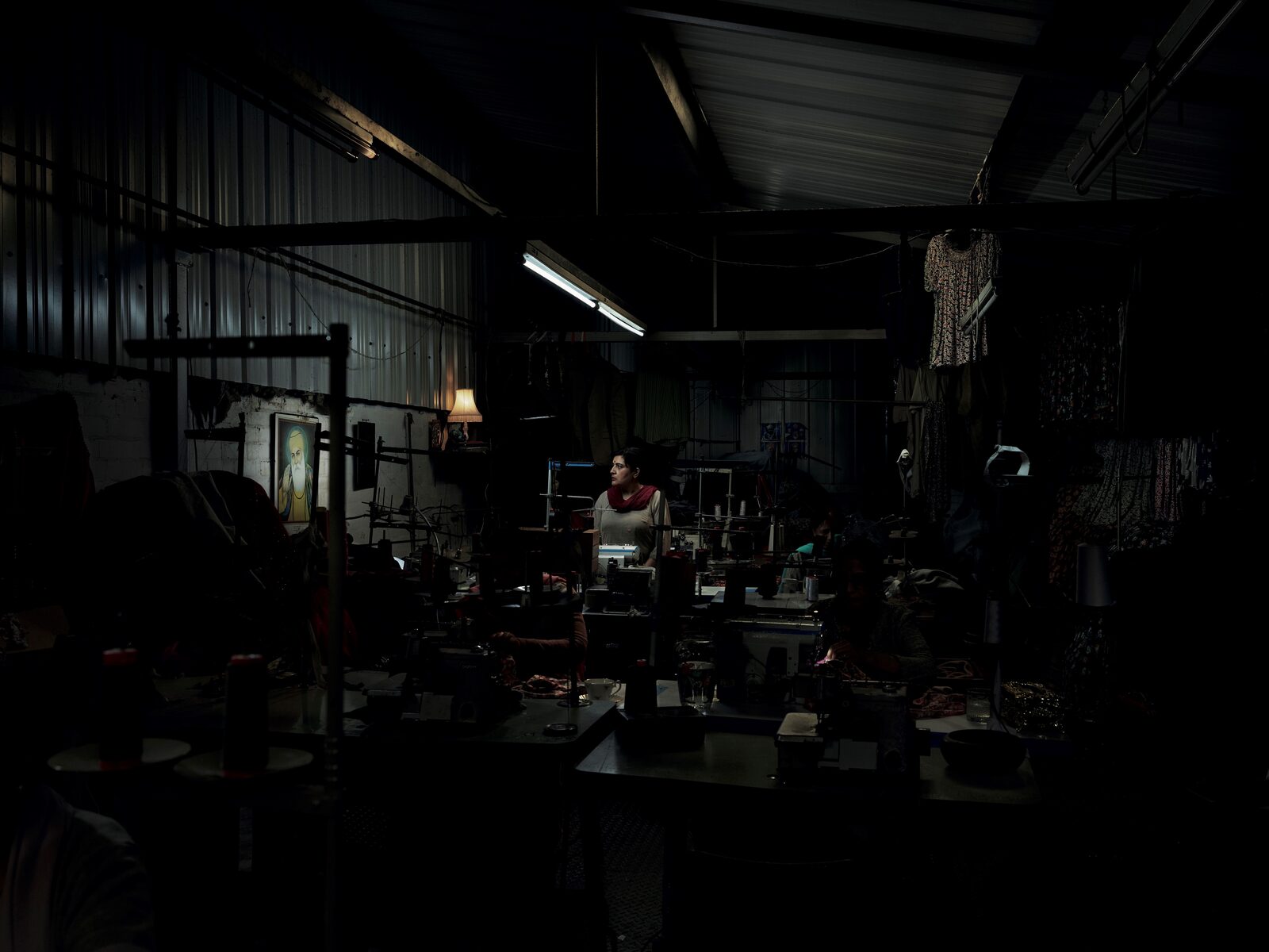 Seamstress, a woman sewing in a factory, from The Exiles photographic series by Billy Dosanjh