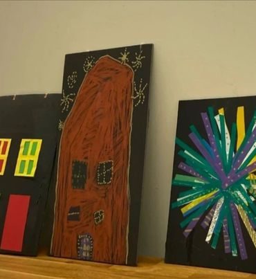 Children's artwork — buildings and fireworks inspired by community stories