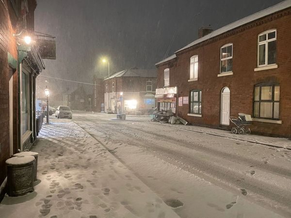 The street set covered in snow at night — location transformed for filming
