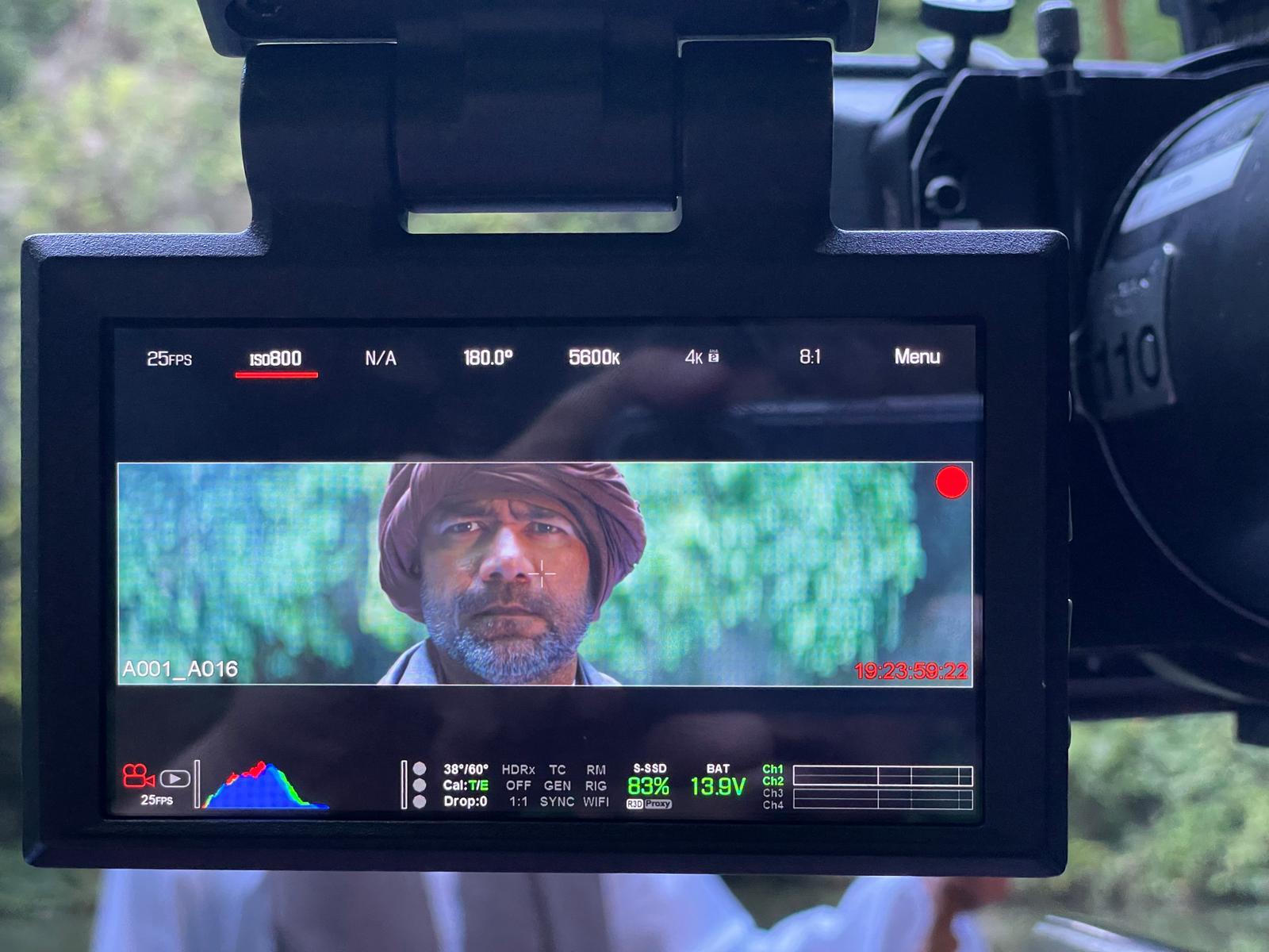 On-set monitor showing Sardar close-up during filming