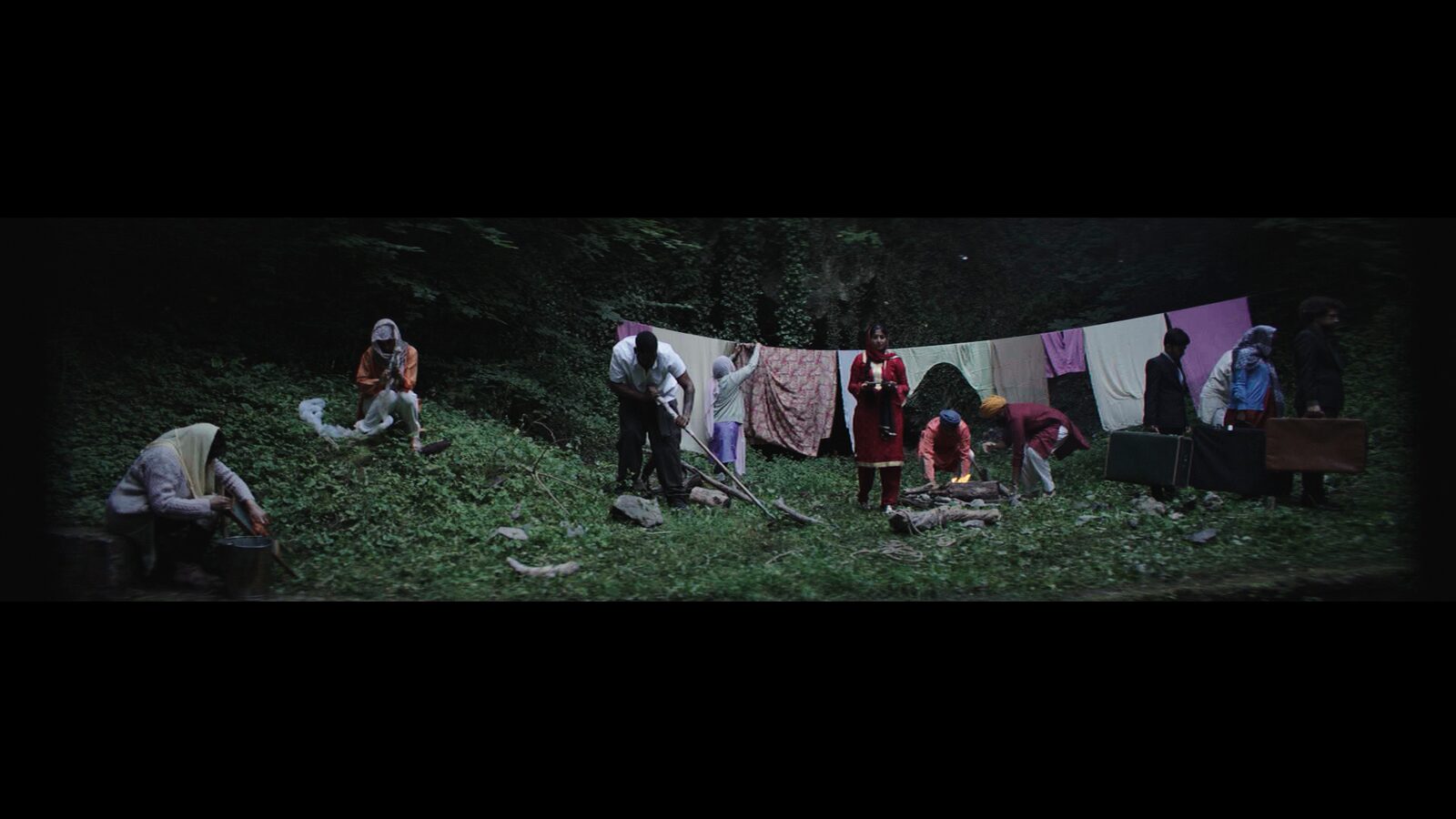 The in-between world — souls gathered around a fire beneath a washing line