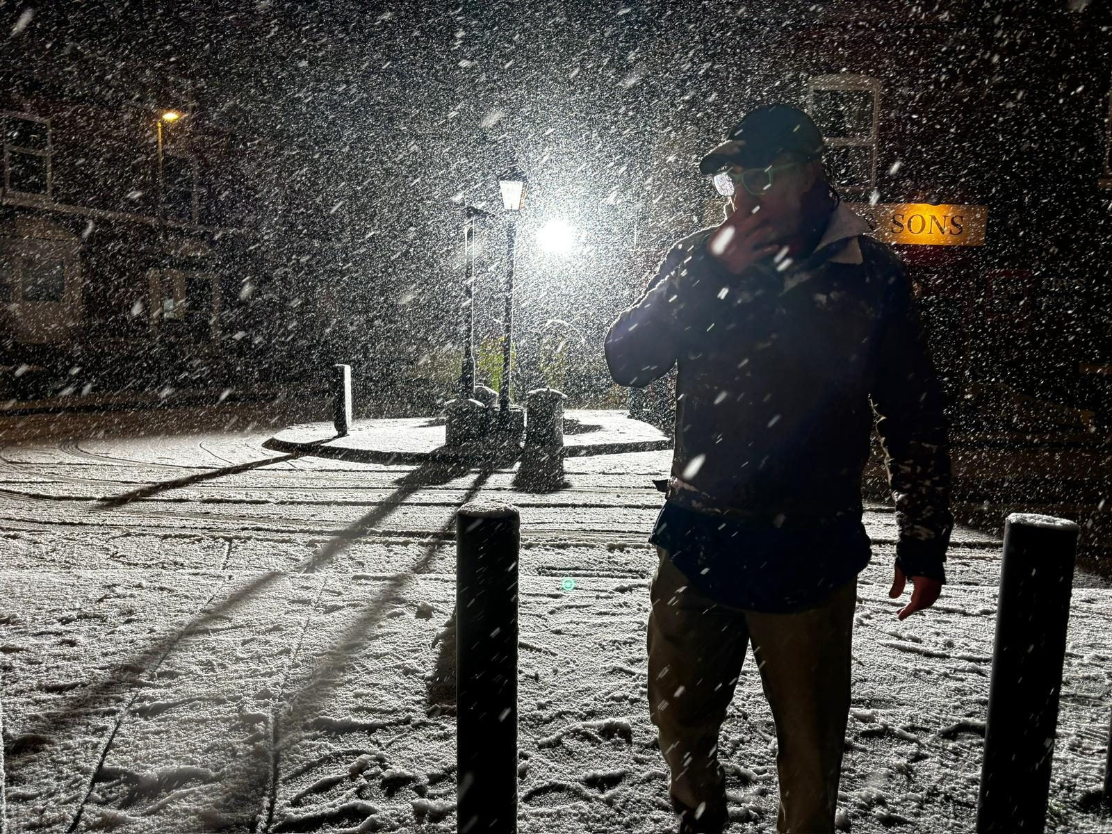 G. Singh & Sons shopfront blanketed in snow at night