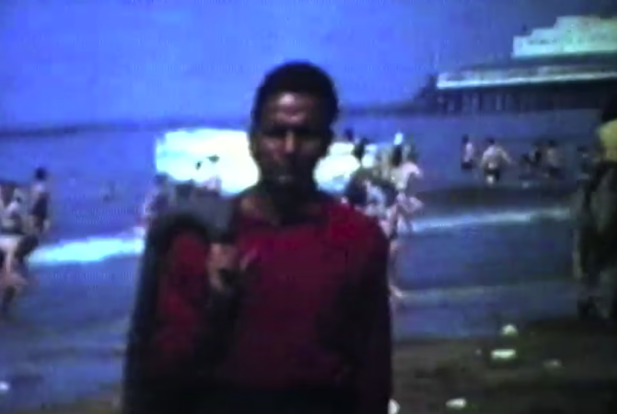 Frame from 1965 — super 8 footage of a man at a British beach