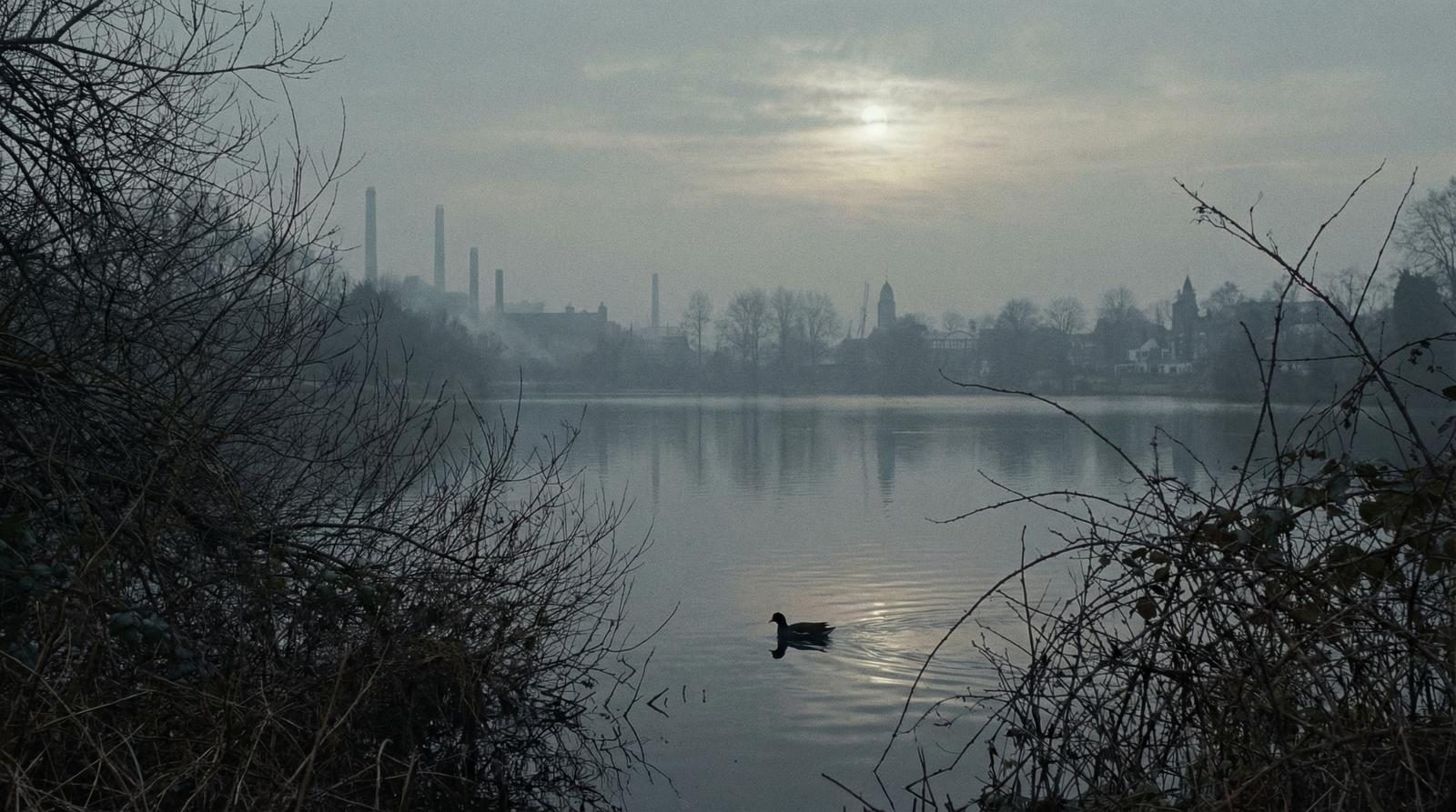 Industrial skyline reflected in still water at dawn — the canal world of the Black Country