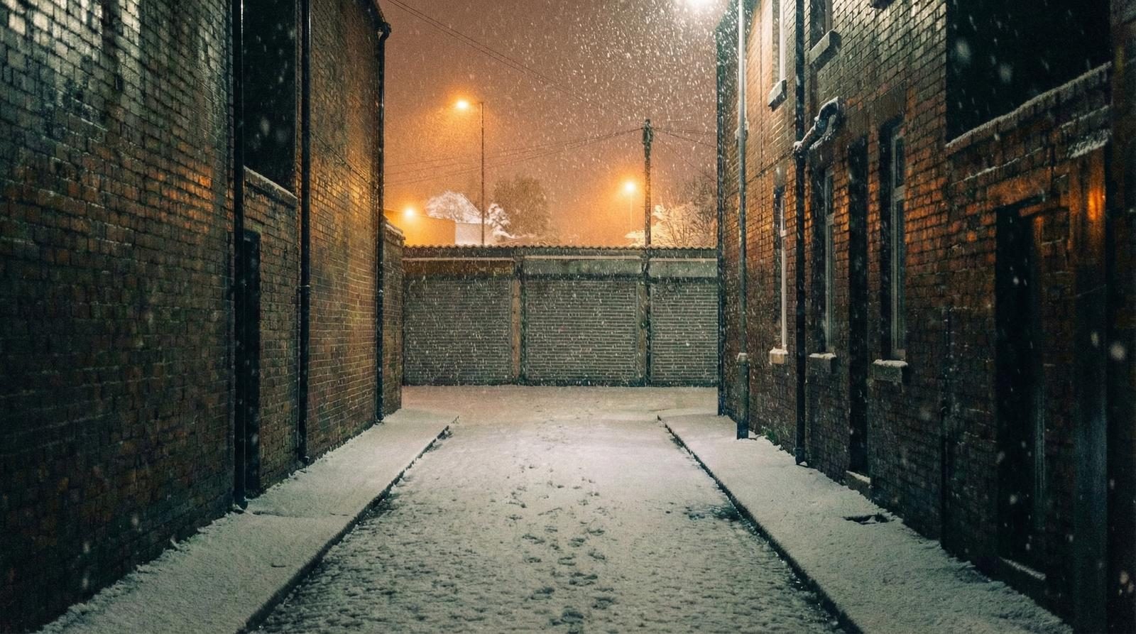 Snow-covered alley with warm lamp light — refuge in winter