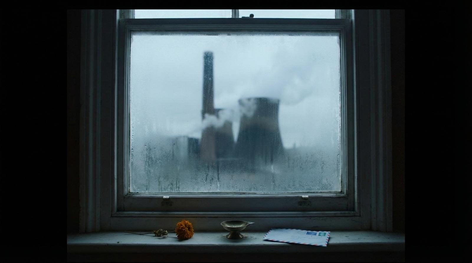 Industrial warehouse interior with sacred imagery, suitcases, and religious iconography — the production world of The Exiles